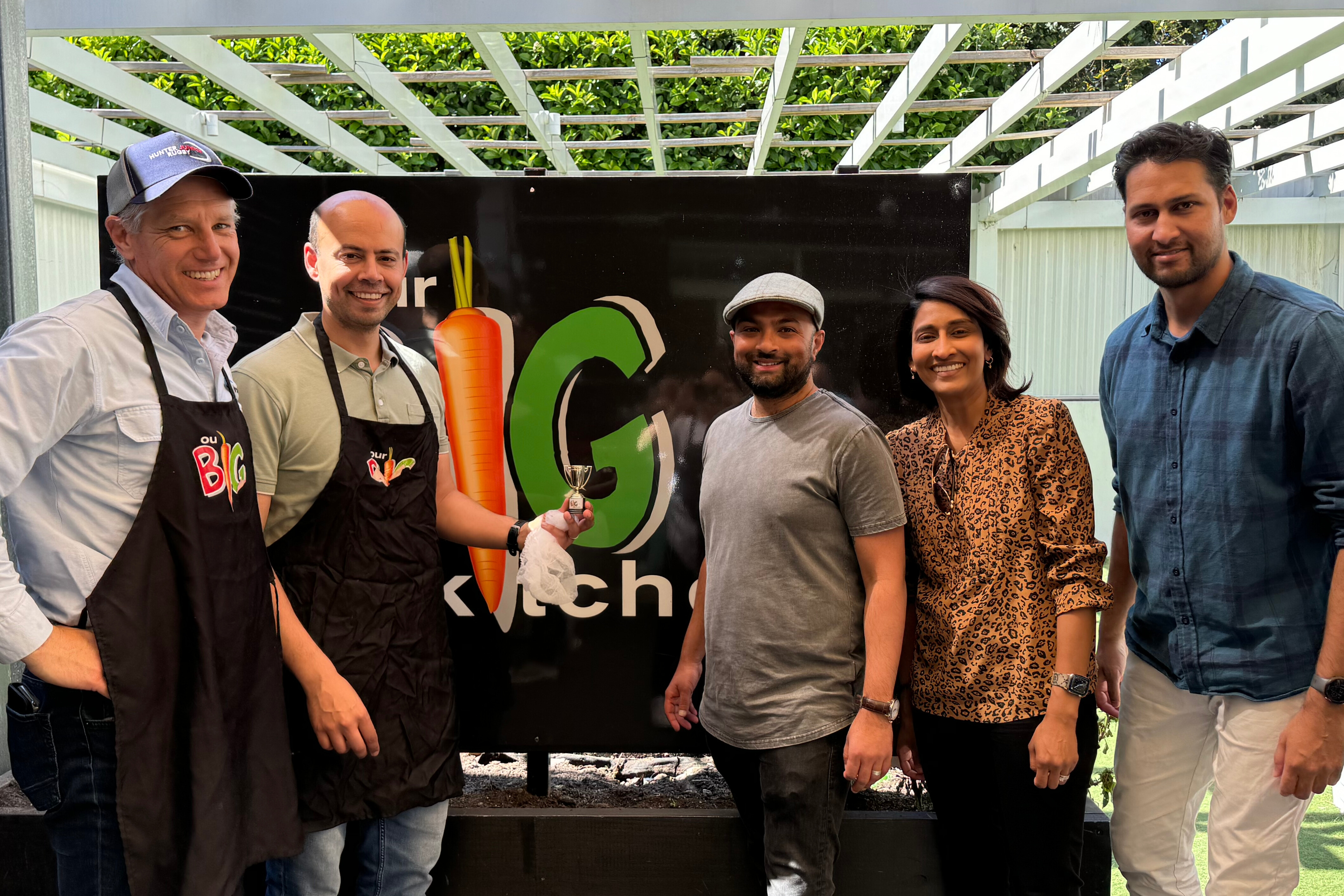 People standing around a BBQ