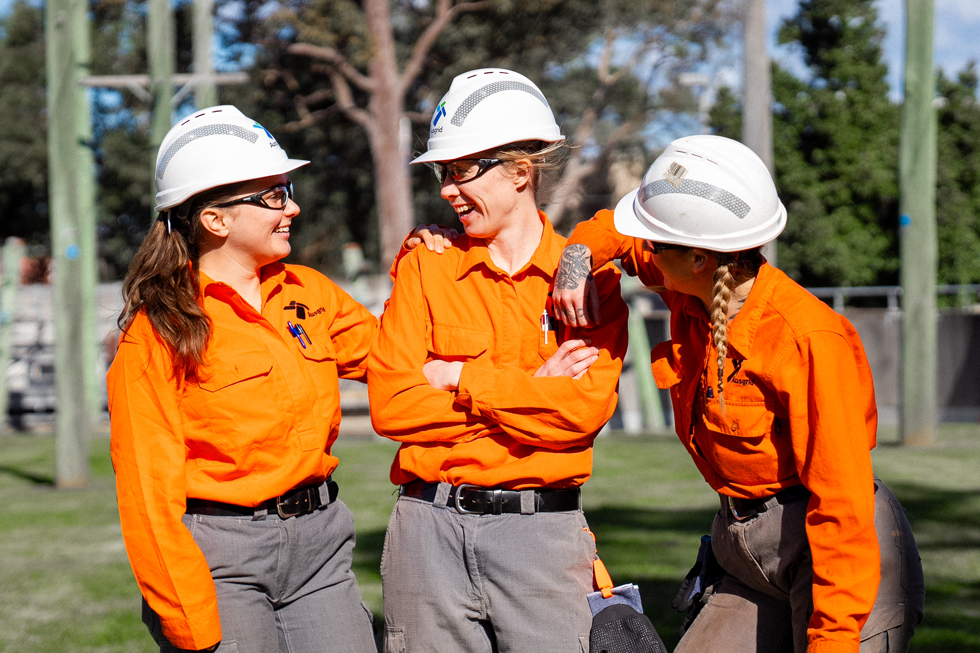 Three Ausgrid women apprentices laughing.