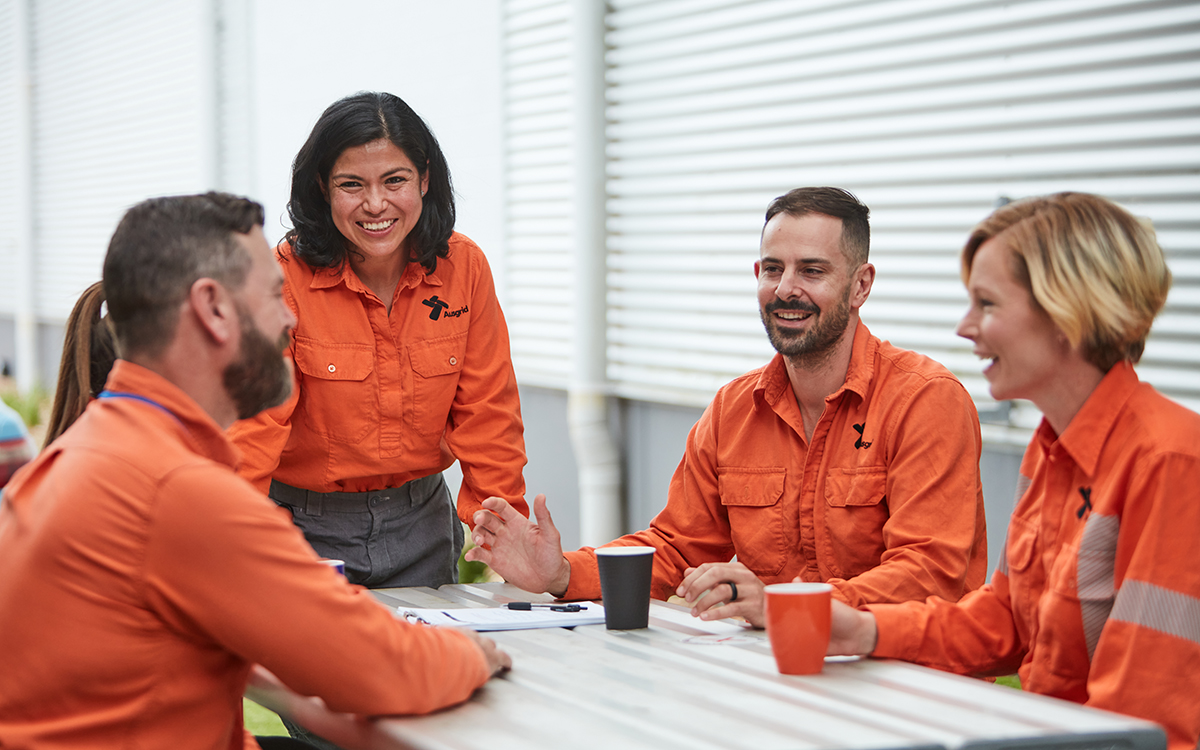 Field operatives in a meeting room chatting