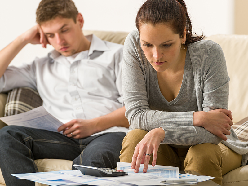 Young couple checking bill