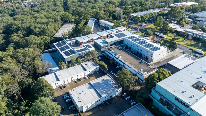 birds eye view of a large industrial building with solar panels on the roof