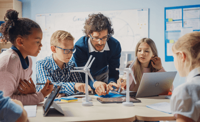 Teacher teaching students about windmills